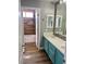Beautiful bathroom featuring a double vanity, tiled floors, and wood-look accent wall at 1705 Pink Cliff Ct, Las Vegas, NV 89128