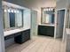 Spacious primary bathroom featuring a double vanity, modern fixtures, and tiled flooring at 1705 Pink Cliff Ct, Las Vegas, NV 89128