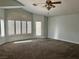 Large living room with carpet, many windows and natural light at 1705 Pink Cliff Ct, Las Vegas, NV 89128