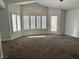 Large living room with carpet, many windows and natural light at 1705 Pink Cliff Ct, Las Vegas, NV 89128