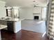 Bright open-concept living room with fireplace and neutral tones, flowing into kitchen with granite countertops at 1705 Pink Cliff Ct, Las Vegas, NV 89128