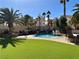Backyard with artificial turf, mature trees, and a large pool with spa and built in BBQ at 1705 Pink Cliff Ct, Las Vegas, NV 89128