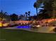 Backyard oasis with a large pool, water features, slide and built in BBQ with bar seating at 1705 Pink Cliff Ct, Las Vegas, NV 89128
