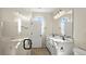 Bright bathroom featuring a double sink vanity, glass shower, and modern fixtures at 1803 Potosi Peak Ave, North Las Vegas, NV 89031