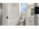 Well-lit bathroom with a tub, modern toilet and a vanity with white cabinets at 1803 Potosi Peak Ave, North Las Vegas, NV 89031