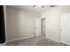 Carpeted bedroom with ceiling fan, and multiple white doors at 1803 Potosi Peak Ave, North Las Vegas, NV 89031