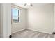 Bright bedroom features neutral carpet, a ceiling fan, and a window with an outside view at 1803 Potosi Peak Ave, North Las Vegas, NV 89031