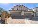 The attached two-car garage provides ample parking and convenience with a paved driveway at 1803 Potosi Peak Ave, North Las Vegas, NV 89031