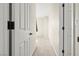 Hallway featuring neutral walls, white doors and carpet at 1803 Potosi Peak Ave, North Las Vegas, NV 89031
