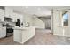 Modern kitchen features white cabinets, quartz countertops, stainless steel appliances, and an island at 1803 Potosi Peak Ave, North Las Vegas, NV 89031