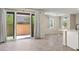 Bright living room offers wood-look floors and sliding glass doors to the back patio at 1803 Potosi Peak Ave, North Las Vegas, NV 89031