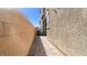 The property offers a clean side yard with neutral stucco and a hardscaped walkway at 1803 Potosi Peak Ave, North Las Vegas, NV 89031