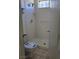 Standing shower features white tiling, and an open door to the toilet at 1805 Monte Alban Dr, North Las Vegas, NV 89031