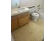Modest bathroom features a toilet, sink with cabinet, and a bathtub with tiled walls at 1805 Monte Alban Dr, North Las Vegas, NV 89031