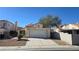 Charming one-story home with a two-car garage, a red tile roof, and a well-kept front yard at 1805 Monte Alban Dr, North Las Vegas, NV 89031