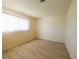 Empty bedroom featuring laminate floors, a window and neutral walls at 1912 W Carey Ave, North Las Vegas, NV 89032