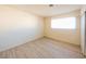 Empty bedroom featuring wood-look laminate flooring and a window at 1912 W Carey Ave, North Las Vegas, NV 89032