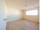 Spacious empty bedroom featuring laminate floors and a window at 1912 W Carey Ave, North Las Vegas, NV 89032