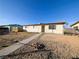 Inviting single-level home with a desert landscape offering simplicity and potential for customization at 1912 W Carey Ave, North Las Vegas, NV 89032