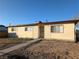 Charming single-story home with a low-maintenance front yard and a classic desert landscape at 1912 W Carey Ave, North Las Vegas, NV 89032
