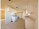 Functional kitchen featuring white cabinetry, gas range, tile flooring, and ample counter space at 1912 W Carey Ave, North Las Vegas, NV 89032