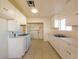 Bright kitchen featuring white cabinets, gas range, tile floors, and an open layout at 1912 W Carey Ave, North Las Vegas, NV 89032