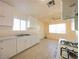 Bright kitchen featuring white cabinets, gas range, tile floors, and an open layout at 1912 W Carey Ave, North Las Vegas, NV 89032