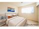 Cozy main bedroom featuring modern decor, laminate floors, and a bright window at 1912 W Carey Ave, North Las Vegas, NV 89032
