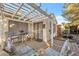 Charming covered back patio with wooden deck, perfect for outdoor relaxation and entertaining guests at 2129 Sun Swept Way, Henderson, NV 89074