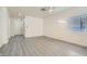 Spacious bedroom with fresh paint, gray floors, and a bright window at 2132 Fred Brown Dr, Las Vegas, NV 89106