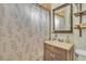 A bathroom features an elegant vanity, decorative shower curtain and open shelving at 239 N Bruce St, Las Vegas, NV 89101