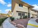 Charming townhouse featuring a well-maintained exterior, mature landscaping, and inviting curb appeal at 2578 Paradise Village Way, Las Vegas, NV 89120