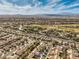 Expansive aerial view of a desert community featuring well-maintained homes and a nearby golf course at 2581 Terrytown Ave, Henderson, NV 89052