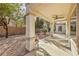 Covered backyard patio with stone pillars and gravel landscaping at 2581 Terrytown Ave, Henderson, NV 89052