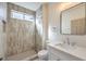 Modern bathroom with glass enclosed shower featuring gray tile and marble-topped vanity at 2581 Terrytown Ave, Henderson, NV 89052