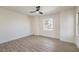 The bright and spacious bedroom is complete with luxury vinyl plank flooring and a single window at 2581 Terrytown Ave, Henderson, NV 89052