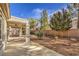 Covered patio with ceiling fan and a desert landscaped yard at 2581 Terrytown Ave, Henderson, NV 89052