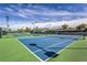 Beautiful blue community tennis courts for recreation and exercise on a sunny day at 2581 Terrytown Ave, Henderson, NV 89052