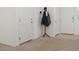 Hallway with neutral carpet and white walls with doors, and coat rack at 2592 Early Sky Ct, Las Vegas, NV 89142