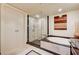 Bathroom featuring a soaking tub, glass-enclosed shower, closet and vanity with granite counter at 2700 Las Vegas Blvd # 4109, Las Vegas, NV 89109
