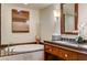 Bathroom showcasing a large soaking tub with granite counter and a decorative vase and painting at 2700 Las Vegas Blvd # 4109, Las Vegas, NV 89109