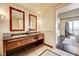 Bathroom featuring double vanity with granite counter, large mirror and doorway to the bedroom at 2700 Las Vegas Blvd # 4109, Las Vegas, NV 89109