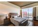 Bedroom with a large window offering city views, wood headboard, and stylish decor at 2700 Las Vegas Blvd # 4109, Las Vegas, NV 89109