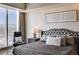 Inviting bedroom features stunning city views from floor-to-ceiling windows and comfortable leather chairs at 2700 Las Vegas Blvd # 4109, Las Vegas, NV 89109