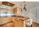 Bright kitchen featuring stainless steel appliances, wooden cabinets, and a granite topped breakfast bar at 2700 Las Vegas Blvd # 4109, Las Vegas, NV 89109