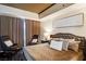 Comfortable main bedroom with a padded headboard, soft lighting, and two lounge chairs at 2700 Las Vegas Blvd # 4109, Las Vegas, NV 89109