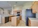 Kitchen with stainless steel appliances, tiled floors, and wooden cabinets at 3412 Amish Ave, North Las Vegas, NV 89031