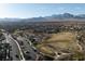 This aerial shot shows a beautiful neighborhood park with the mountains in the background at 361 Black Turnstone Ct, Las Vegas, NV 89138