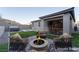 A beautiful backyard with a fire pit, seating area, hot tub and well manicured grass at 361 Black Turnstone Ct, Las Vegas, NV 89138