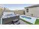 This beautiful backyard features a hot tub, splash pool, and artificial grass at 361 Black Turnstone Ct, Las Vegas, NV 89138